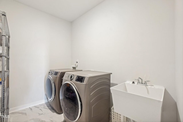 laundry room featuring washing machine and clothes dryer and sink