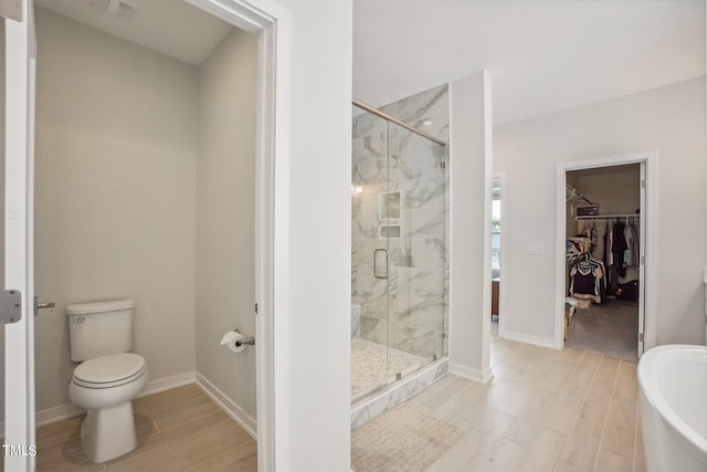 bathroom featuring shower with separate bathtub and toilet