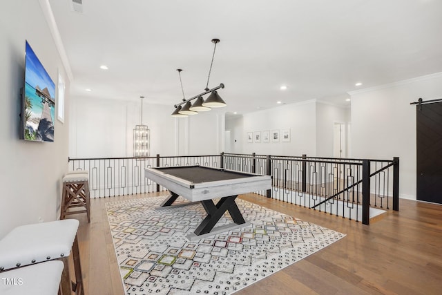 game room with crown molding, hardwood / wood-style flooring, and a chandelier