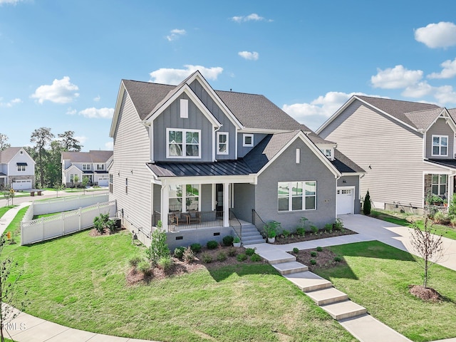 view of front of house featuring a garage, covered porch, and a front yard