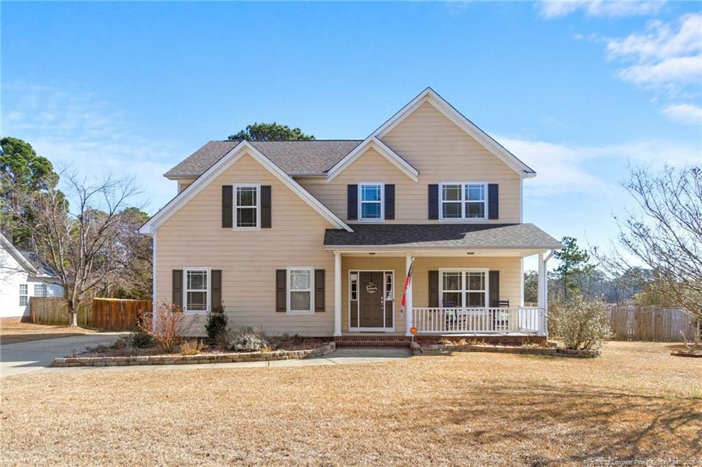 view of front of property with a front yard and a porch