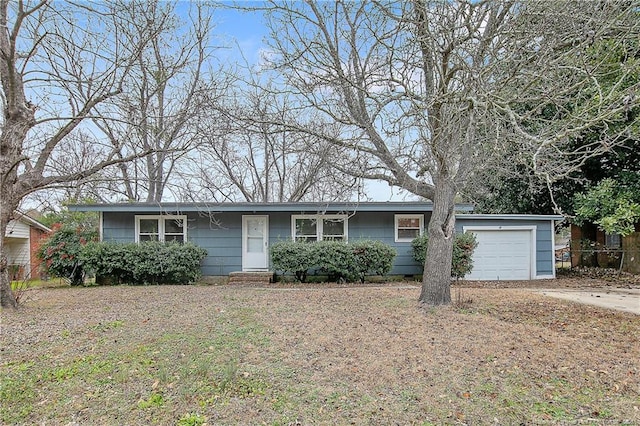 ranch-style house with a garage and driveway