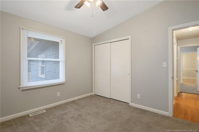 4442 Wellington Dr, Fayetteville, NC 28314 - unfurnished bedroom featuring a closet, visible vents, light carpet, vaulted ceiling, and baseboards