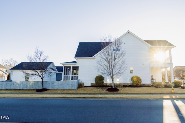 view of home's exterior featuring a sunroom and a balcony