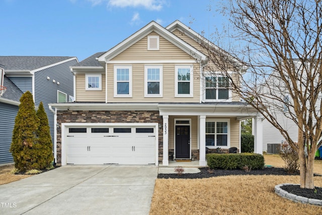 view of front of property featuring a garage, a porch, and central AC unit