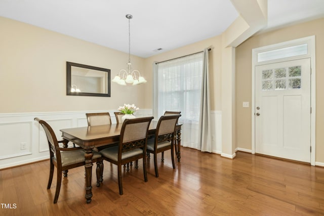 dining space with a chandelier, hardwood / wood-style floors, and a wealth of natural light