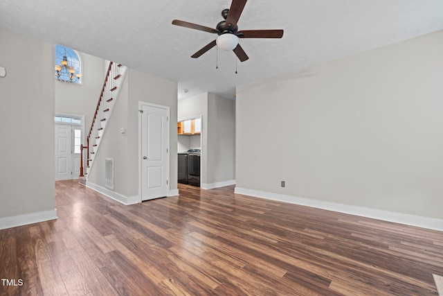 unfurnished living room featuring ceiling fan, dark wood-type flooring, and a textured ceiling