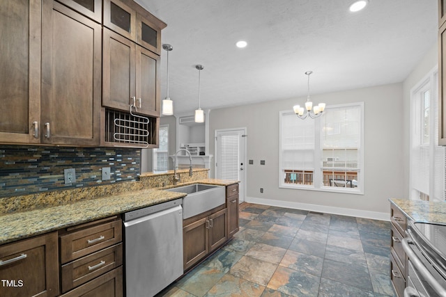 kitchen featuring dishwasher, light stone countertops, sink, and pendant lighting