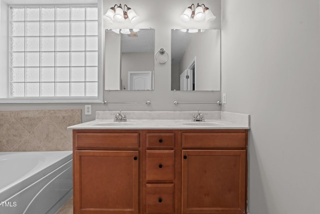 bathroom with vanity and a tub