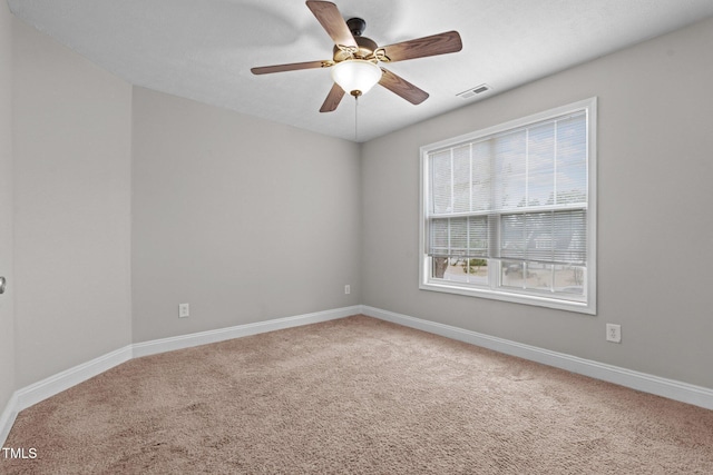 spare room featuring carpet floors and ceiling fan