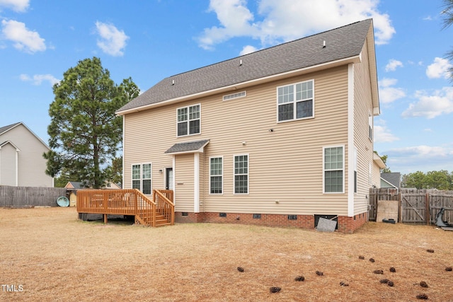 rear view of house featuring a yard and a deck