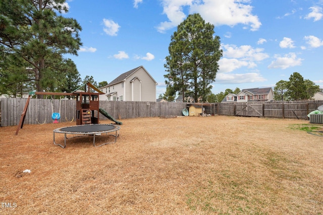 view of yard with a playground and a trampoline