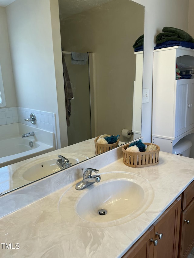 bathroom with vanity and a tub