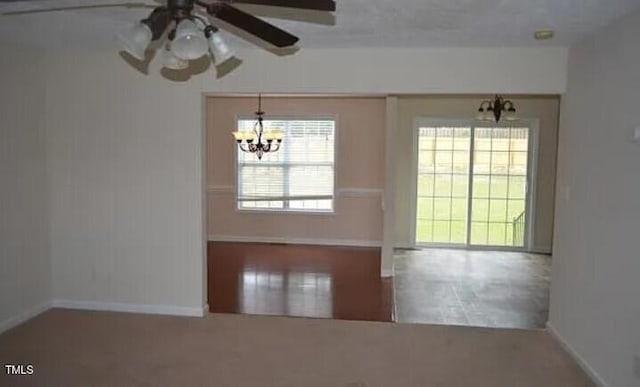 spare room with a notable chandelier