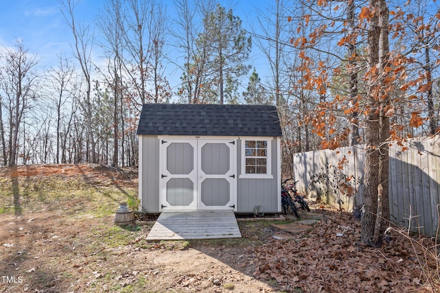 view of shed with fence