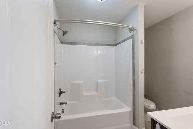 bathroom with shower / washtub combination, vanity, and toilet