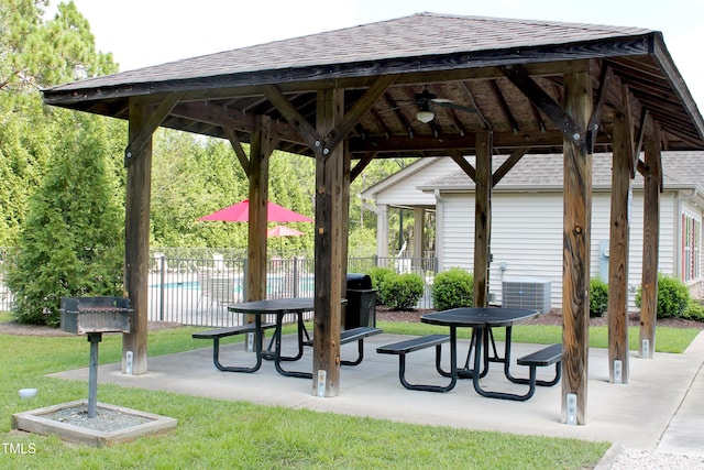 view of community with a gazebo, a yard, a patio area, and fence