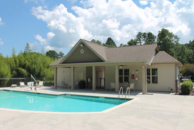 pool with ceiling fan, fence, area for grilling, and a patio