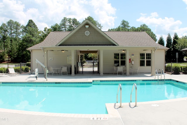 community pool featuring fence and a patio