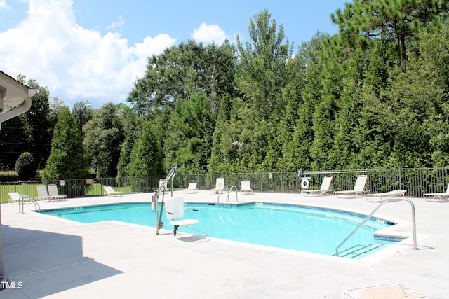 community pool featuring a patio and fence