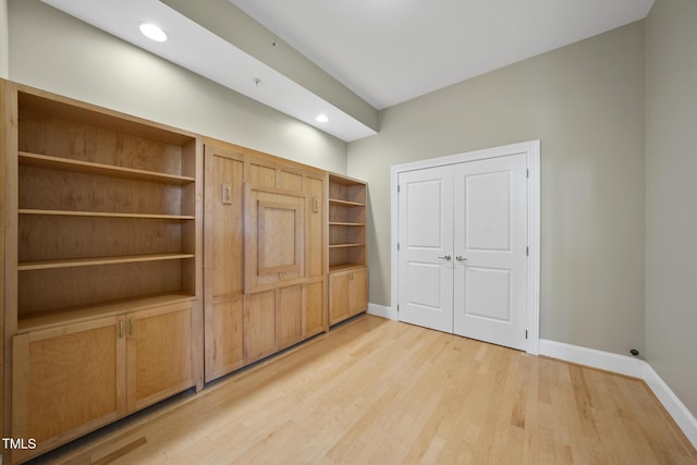 unfurnished bedroom with light hardwood / wood-style floors and a closet