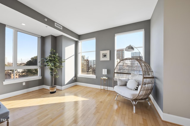 sitting room with a healthy amount of sunlight and light hardwood / wood-style floors