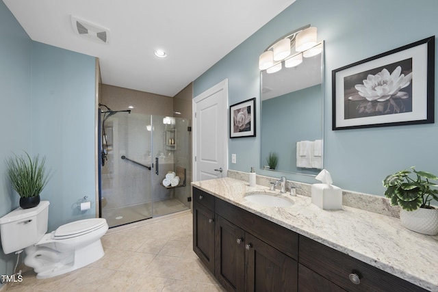 bathroom with vanity, tile patterned flooring, a shower with door, and toilet