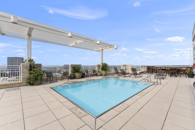 view of swimming pool with a pergola and a patio