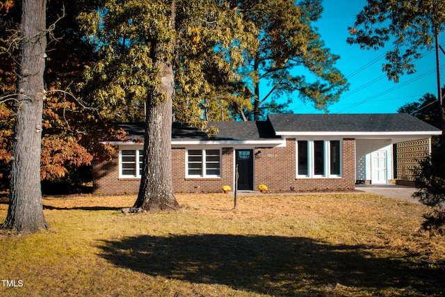 ranch-style home featuring a front yard and a carport