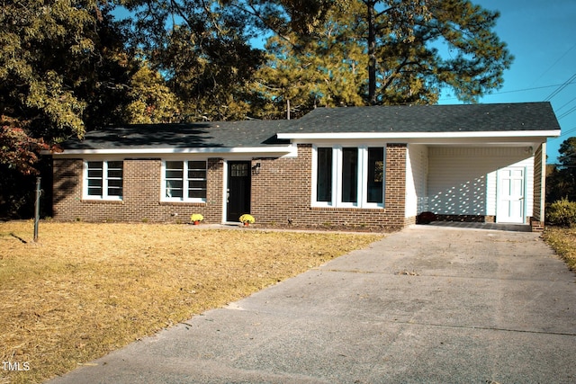 view of front facade with a carport and a front lawn