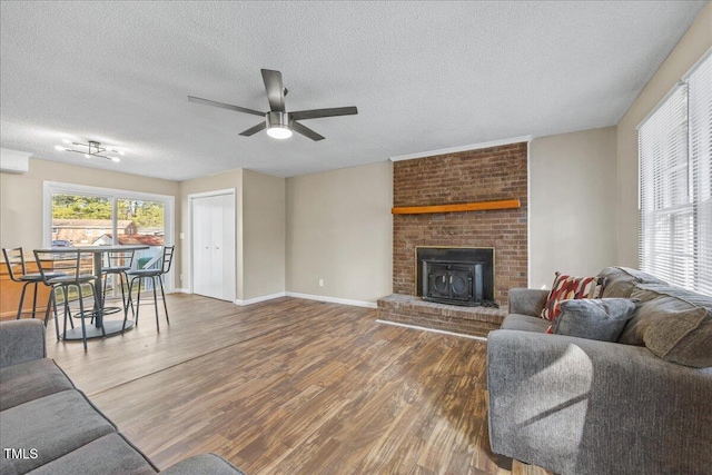 living room with ceiling fan, dark hardwood / wood-style floors, and a textured ceiling