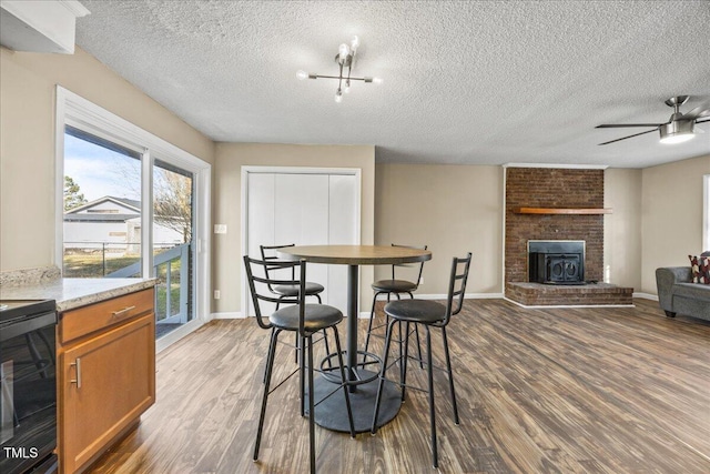 dining room featuring ceiling fan, hardwood / wood-style floors, and a textured ceiling