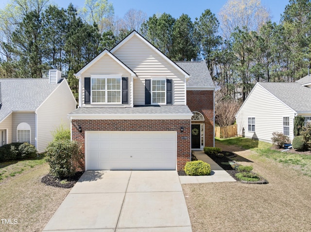 traditional-style house with brick siding, a front yard, driveway, and a garage