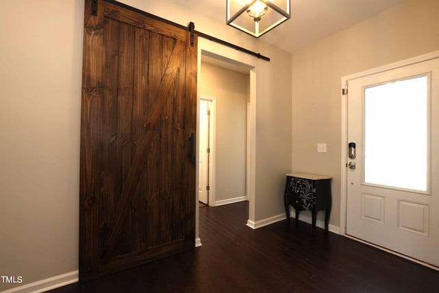 foyer entrance featuring dark hardwood / wood-style flooring and a barn door