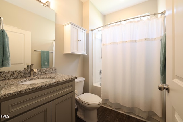 full bathroom with hardwood / wood-style flooring, toilet, vanity, and shower / bath combo with shower curtain