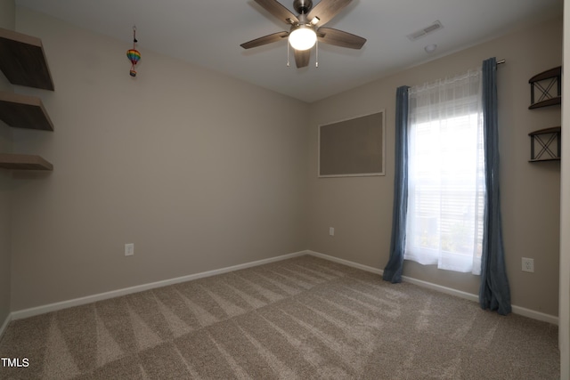 unfurnished room with ceiling fan and light colored carpet