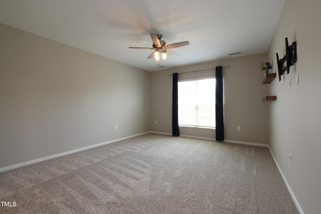 spare room with light colored carpet and ceiling fan