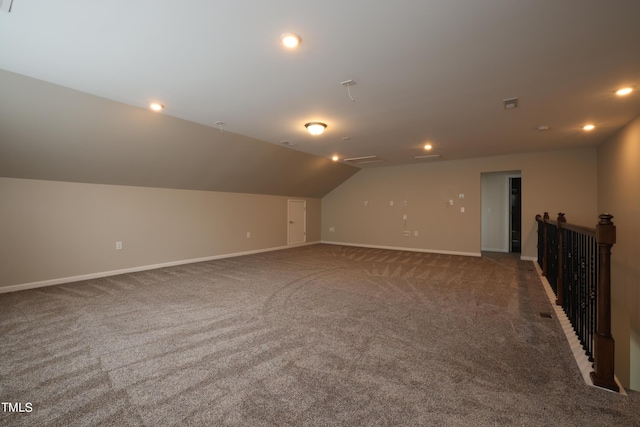 bonus room with lofted ceiling and carpet