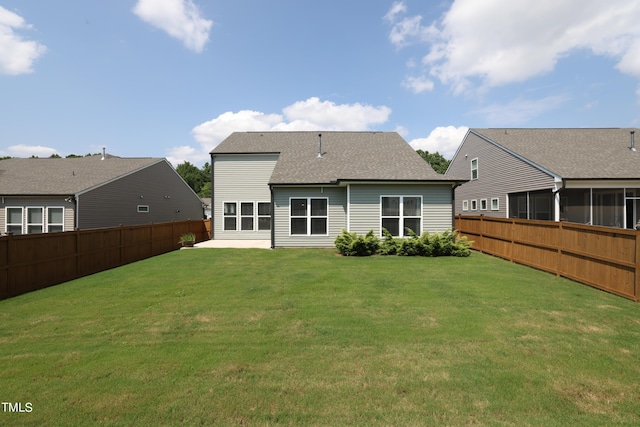 back of property featuring a lawn