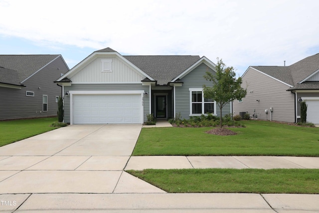 view of front of property featuring a garage and a front lawn