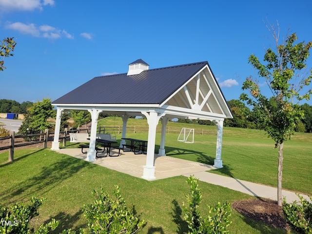 view of property's community featuring a gazebo, a yard, and a patio area