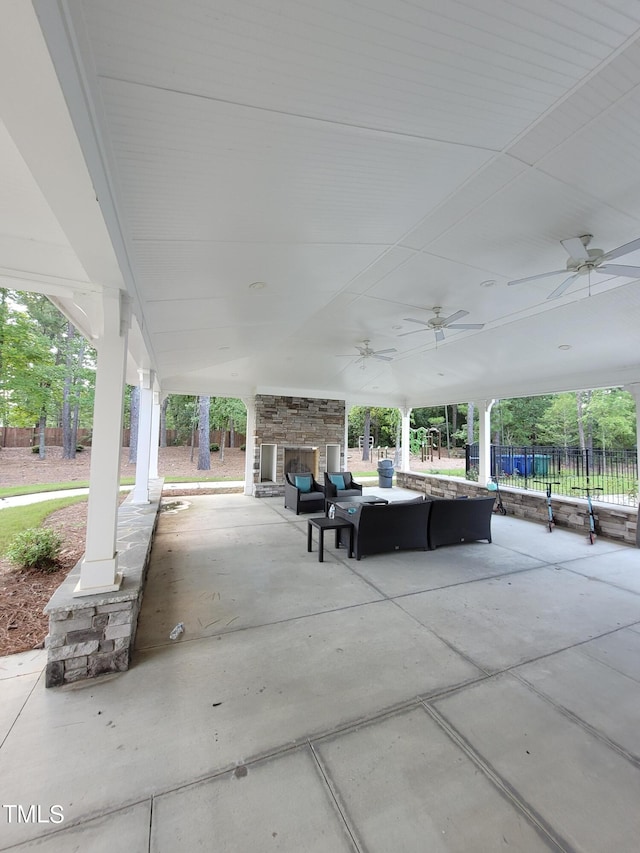 view of patio / terrace with ceiling fan and an outdoor stone fireplace