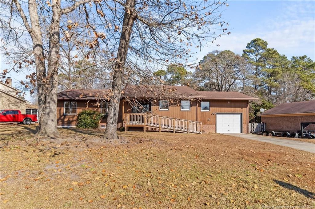 ranch-style home featuring a garage and a front yard