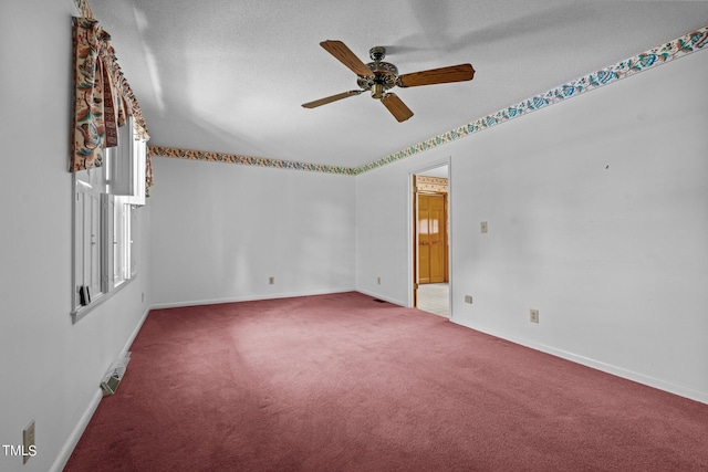 spare room featuring ceiling fan, carpet floors, and a textured ceiling