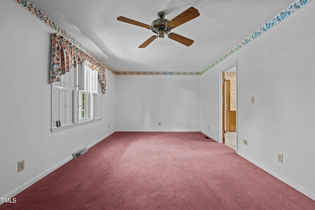 empty room featuring ceiling fan, carpet, and a textured ceiling