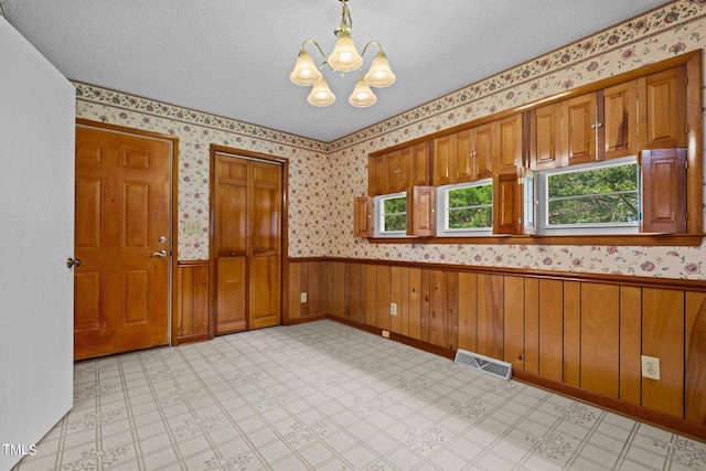 kitchen featuring pendant lighting and a chandelier