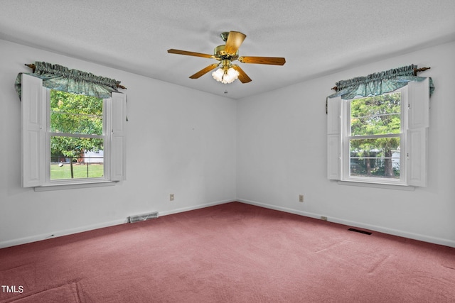 unfurnished room featuring ceiling fan, carpet floors, and a textured ceiling