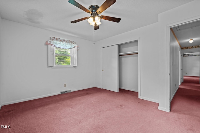 unfurnished bedroom with light carpet, ceiling fan, and a closet