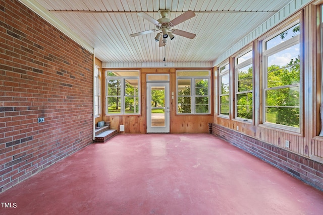 unfurnished sunroom featuring ceiling fan