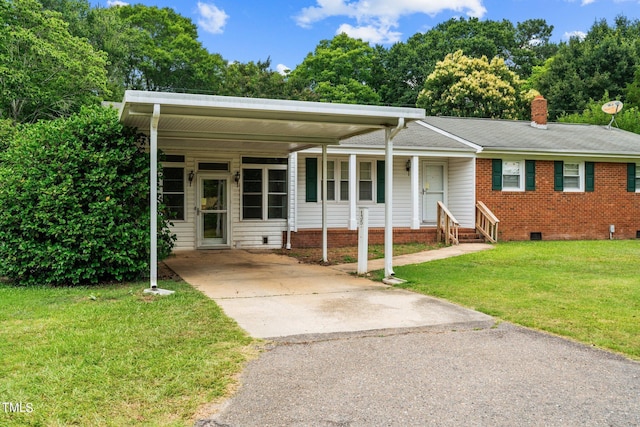 view of front facade with a carport and a front yard